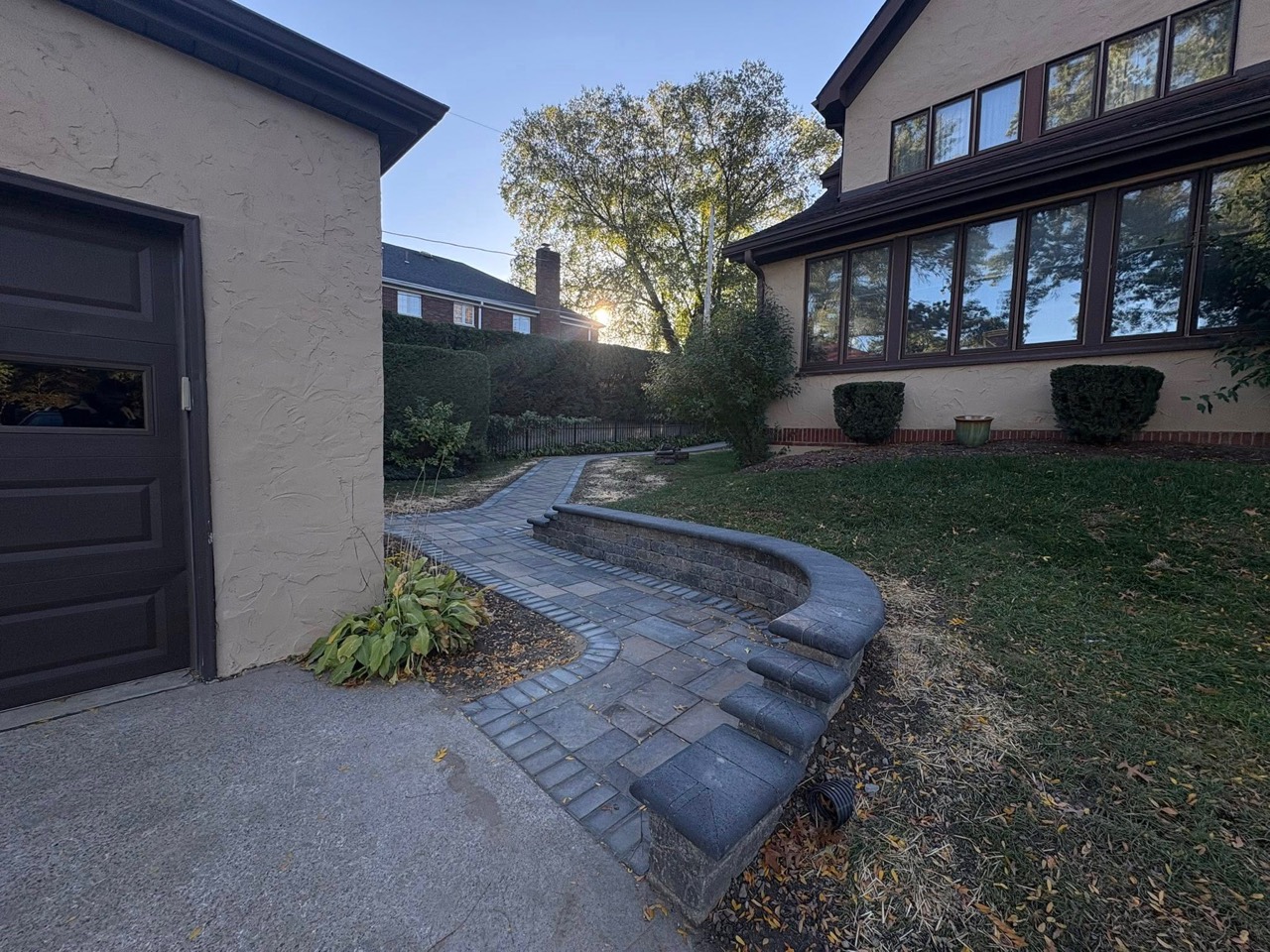 Finished landscaped pathway and curved retaining wall